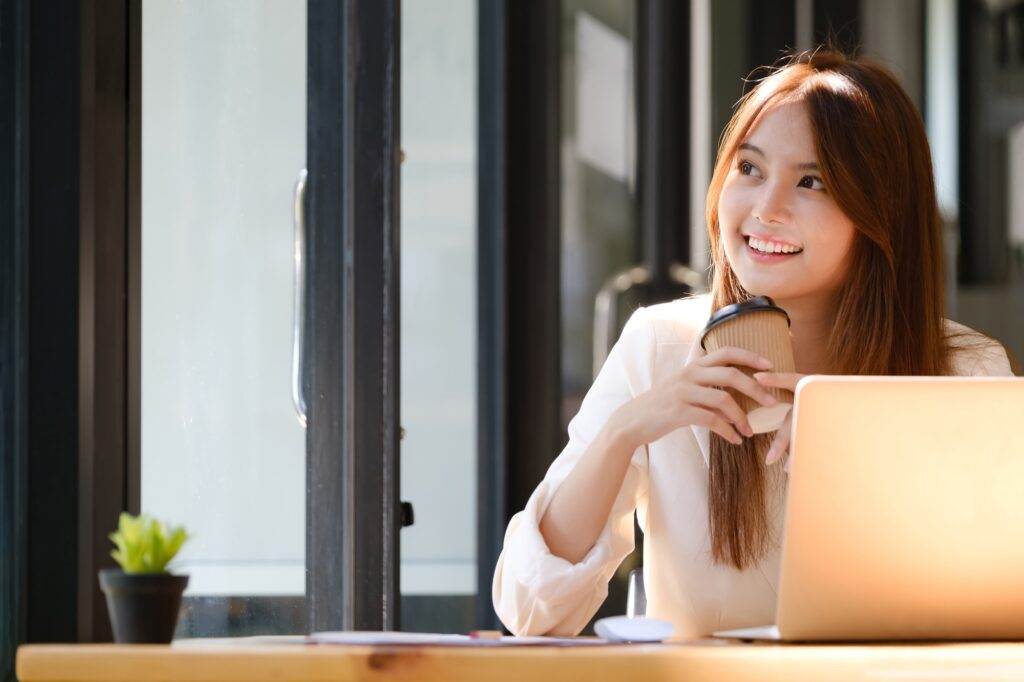 Happy businesswoman relaxing at office desk