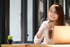Happy businesswoman relaxing at office desk