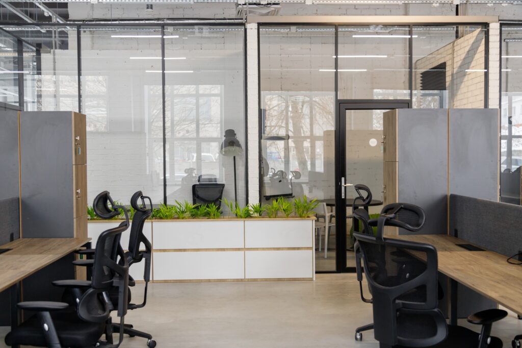 Interior of modern coworking space without people, containing tables and chairs
